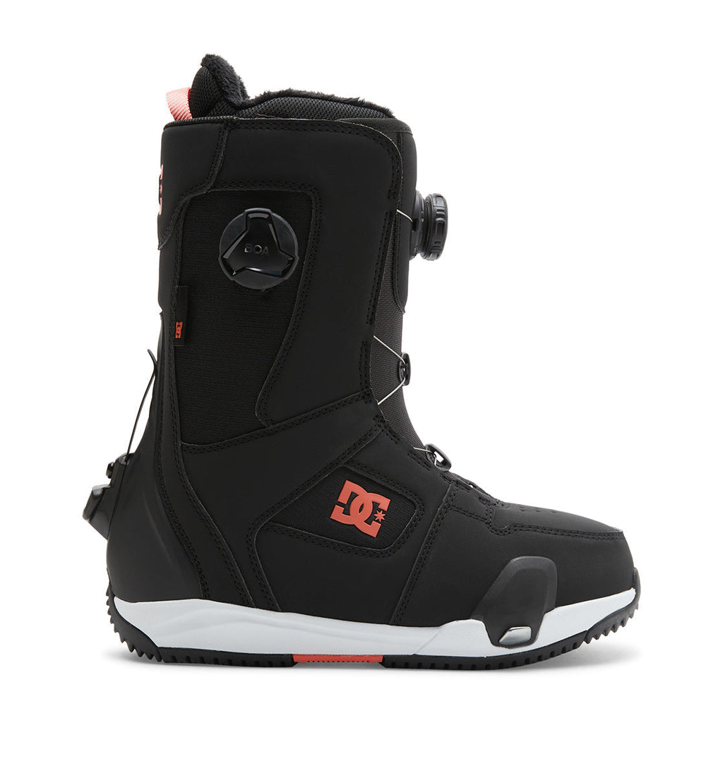 Presenting the Women’s Phase BOA® Pro Step On® Snowboard Boots by DC Shoes in black with striking red accents, this boot showcases the DC Shoes logo and features a Dual Zone BOA® Fit System for precision adjustment, along with a durable sole—all displayed in a side profile against a white background.