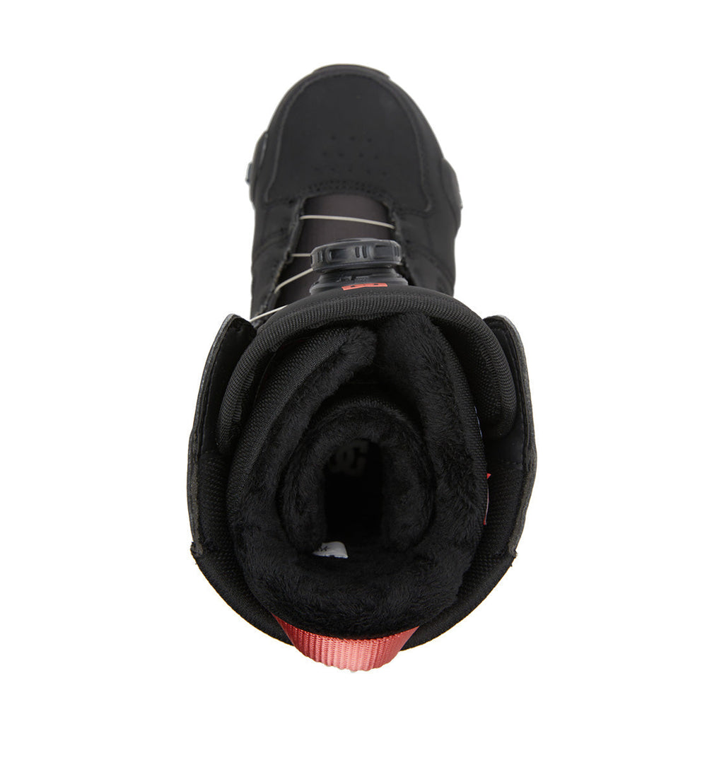 Top view of the DC Shoes Women’s Phase BOA® Pro Step On® Snowboard Boot in black, featuring a plush inner lining and a red pull tab at the heel. This style, tailored for women snowboarders, showcases a round toe and a lace-free Dual Zone BOA® Fit System closure for superior convenience and support.