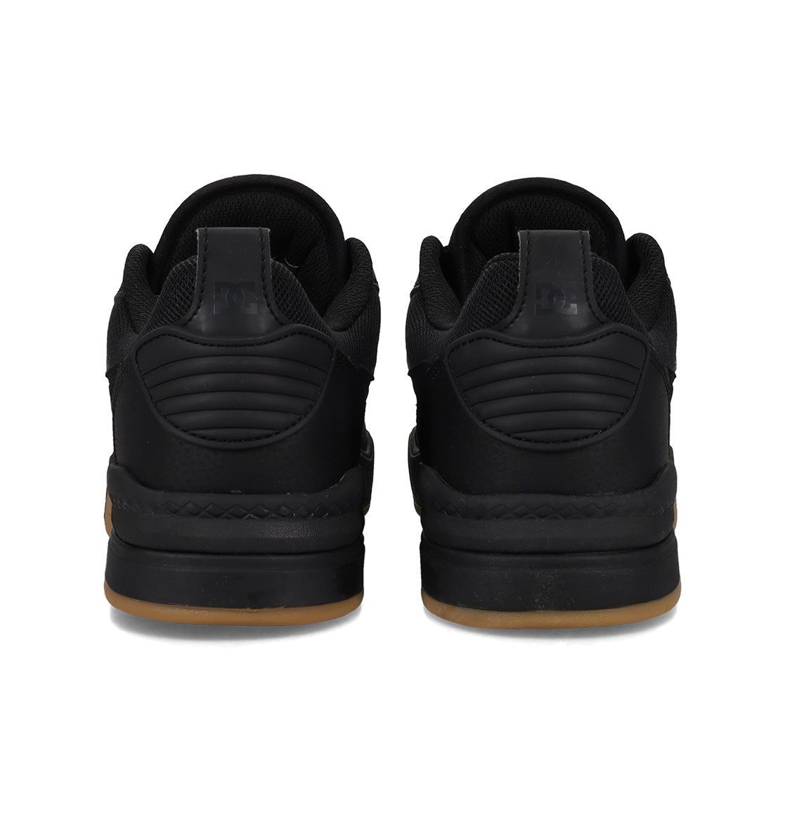 A pair of black DC Shoes Men’s Ascend Skate Shoes viewed from the back, featuring thick soles with a light brown gum base, quilted heel detailing, and black laces—these sneakers seamlessly blend modern comfort with timeless style.
