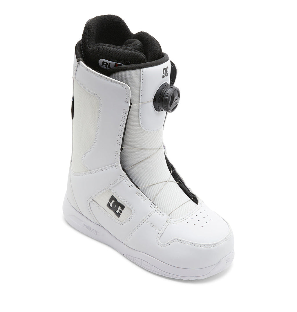 The Women’s Phase BOA® Snowboard Boots by DC Shoes feature a white exterior with a black interior, the convenient side-mounted BOA® Fit System dial lacing, and the iconic DC logo on the outer ankle. Designed for durability, these boots also include reinforced stitching and a sturdy rubber sole.