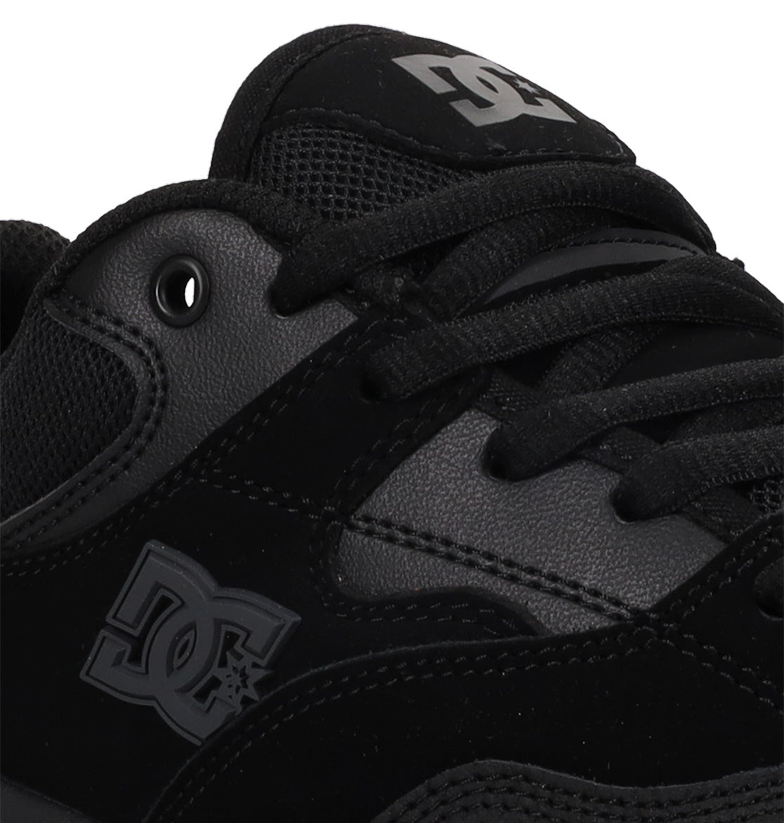 Close-up of a black DC Shoes Men’s Ascend Skate Shoe featuring the side DC logo, laces, and a glimpse of the padded tongue with branded detailing. The shoe combines leather, suede, and mesh textures for a blend of modern comfort and classic skate sneaker style.