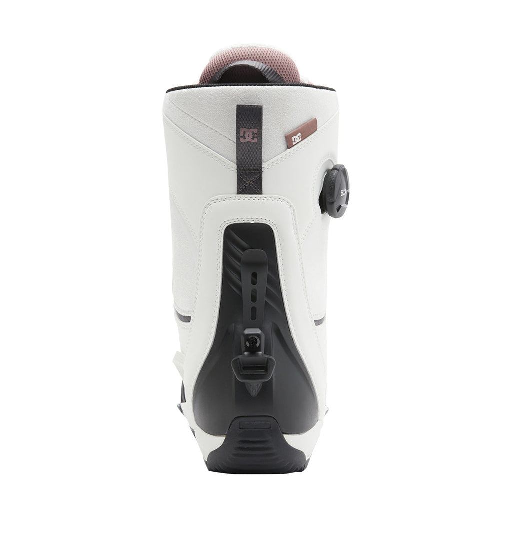 Rear view of a single light gray DC Shoes Women’s Lotus Step On® Snowboard Boot featuring a black adjustable heel mechanism and a side dial. The padded top collar includes a small brown DC logo tag near the upper edge.