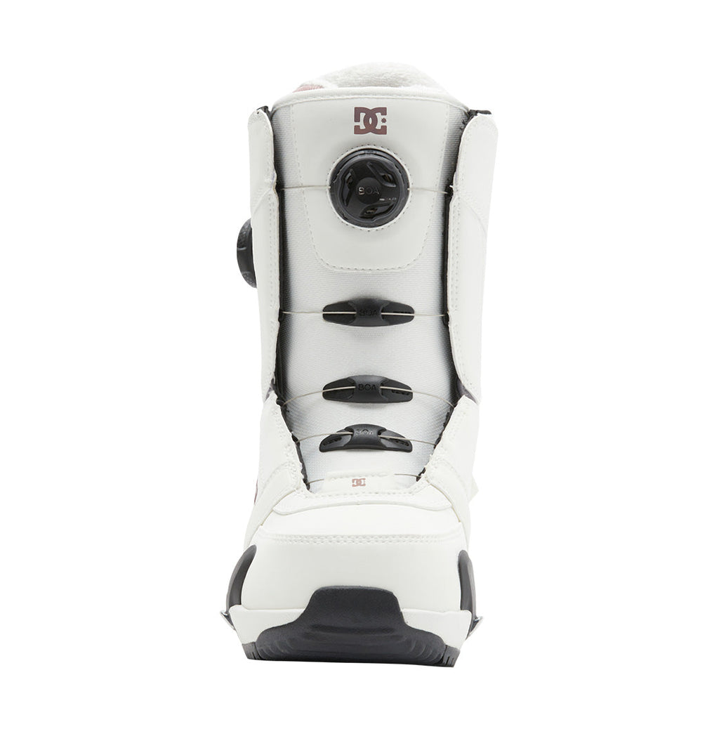 The Women’s Lotus Step On® Snowboard Boot by DC Shoes features a white design with black accents, a front-facing Dual Zone BOA Fit System, and the DC Shoes logo near the top. Its sole is textured with both black and white details.