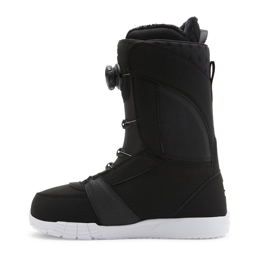 A side view of the DC Shoes Women’s Lotus BOA® Snowboard Boots, showcasing a black design with a white Unilite outsole, BOA® Fit System dial closure, and reinforced stitching.