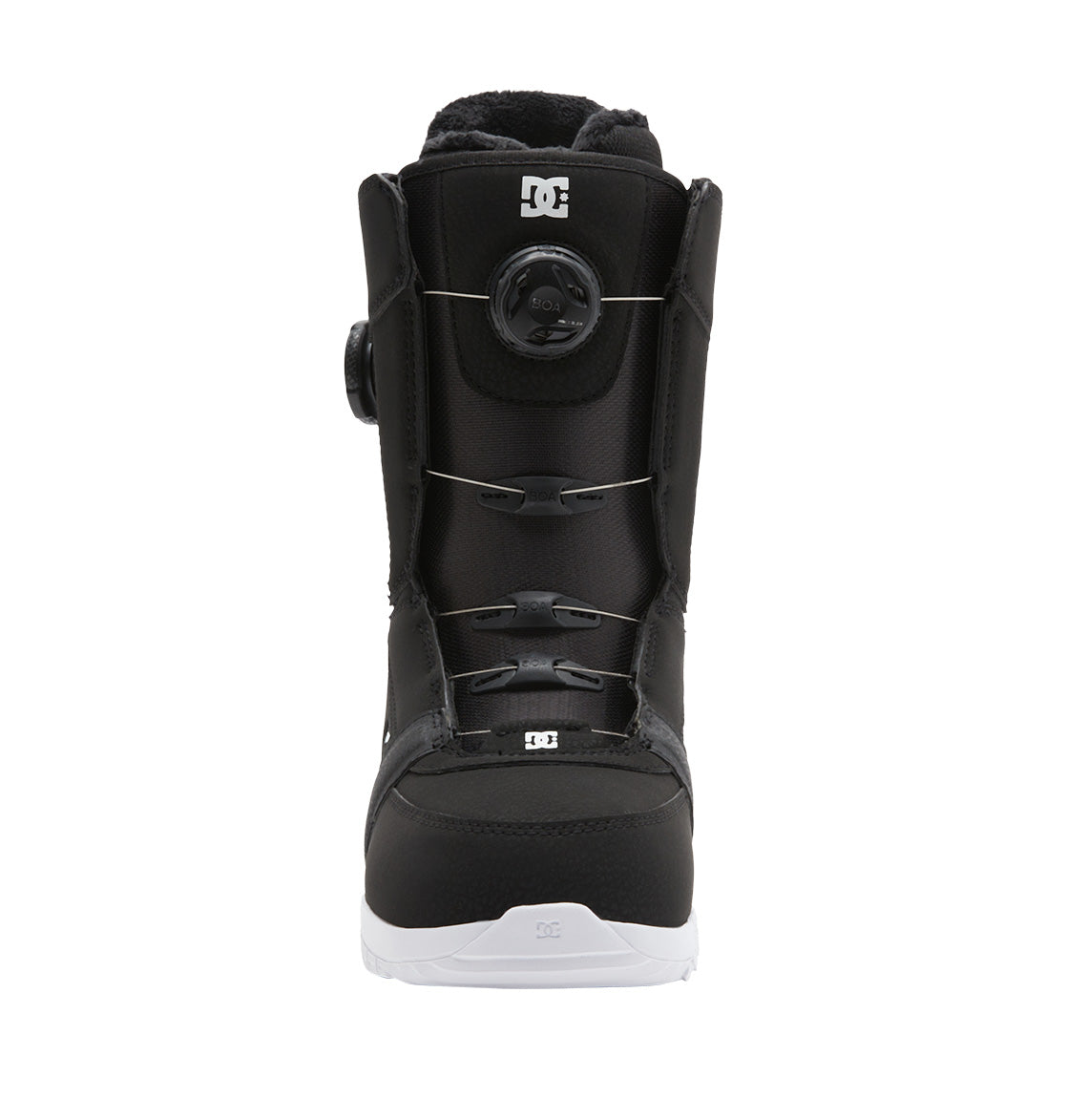 The DC Shoes Women’s Lotus BOA® Snowboard Boot is pictured centered and facing forward, showcasing its black design with a white Unilite outsole, a round BOA® Fit System tightening dial, and DC logo accents on the tongue and toe, photographed on a plain white background.