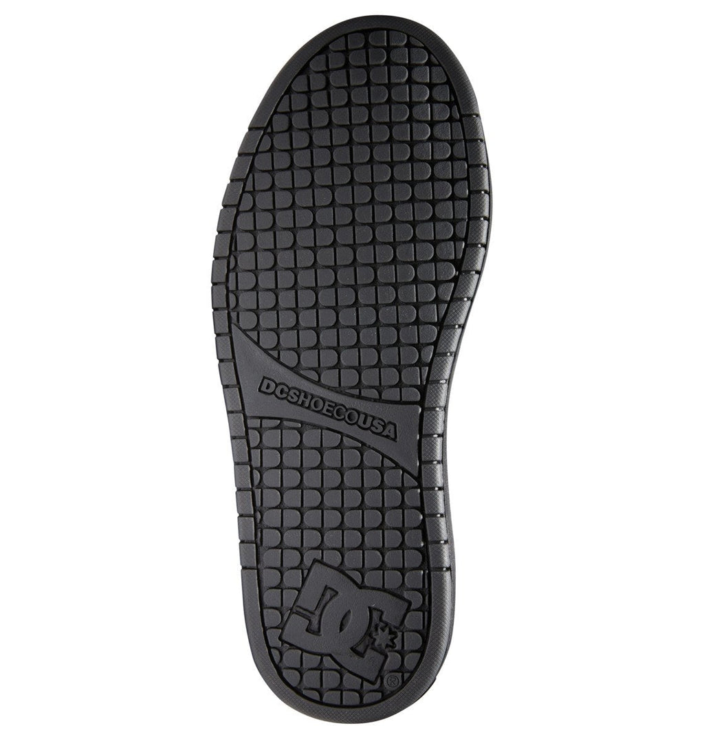 The Men’s Court Graffik Shoes from DC Shoes feature a black sole with a textured grid pattern, DCSHOECOUSA text centered, and a bold DC logo with star detail at the heel—hallmarks of the shoe’s iconic puffy silhouette. The sole is shown against a white background.