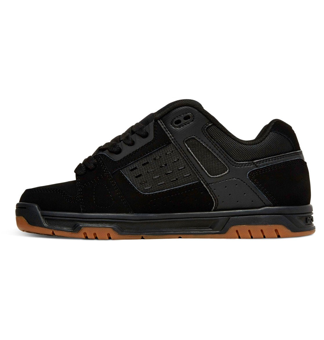 The DC Shoes Men’s Stag Shoes are black low-top athletic sneakers featuring a durable cupsole, mesh panels, and textured accents, shown from the side against a white background—perfectly showcasing the iconic style of DC Shoes.