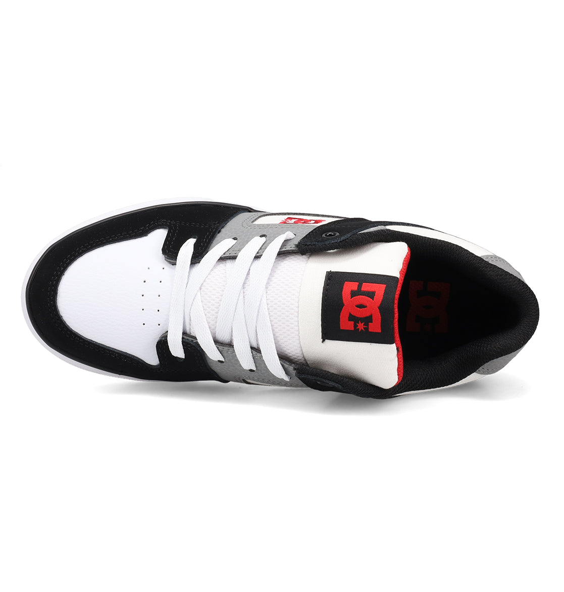 The Kids’ Pure Shoes by DC Shoes feature a black, white, and gray color scheme and are shown from above with white laces, a perforated toe box, and the signature red DC logo on the black tongue—stylish and durable skate shoes designed for kids’ comfort.