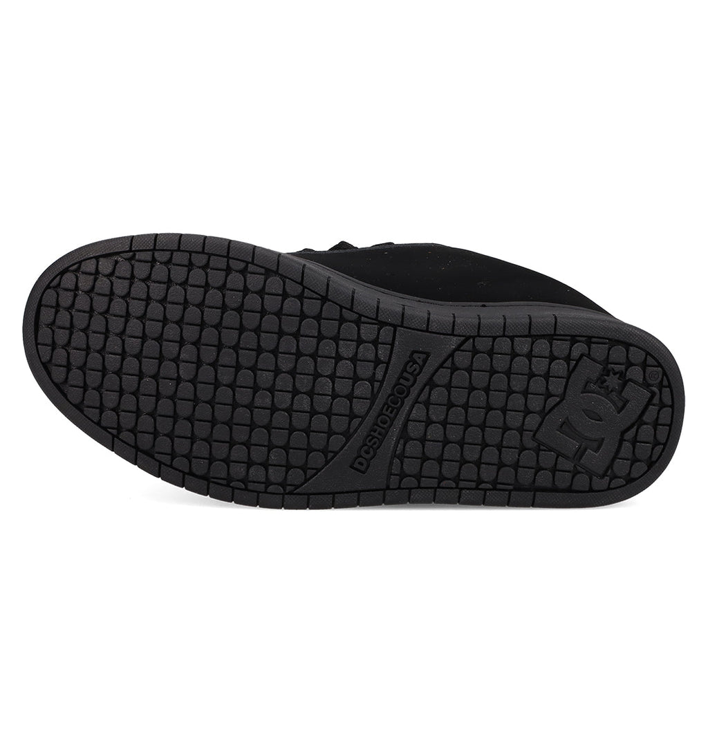 The image displays the black rubber sole of the DC Shoes Men's Court Graffik, featuring a grid-like tread and embossed DC logo near the heel, along with "DURABILITÉ.