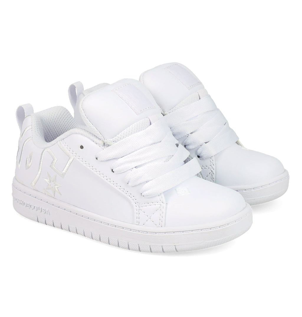 The DC Shoes Kids' Court Graffik Shoes are white low-top sneakers with thick white laces, a chunky sole, subtle embossed logo, and side stitching details, inspired by classic skate styles.