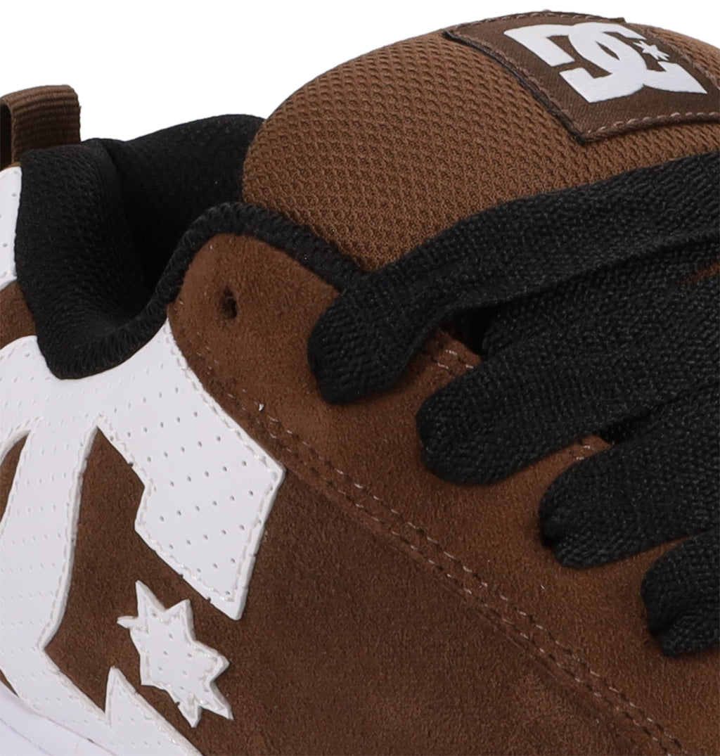 Close-up of the Men’s Court Graffik Special Edition Shoes by DC Shoes in brown and white, accented with black laces and highlighted by the iconic DC logo on both the tongue and side. Crafted from suede and mesh in DC’s signature puffy silhouette inspired by their popular Court Graffik style.