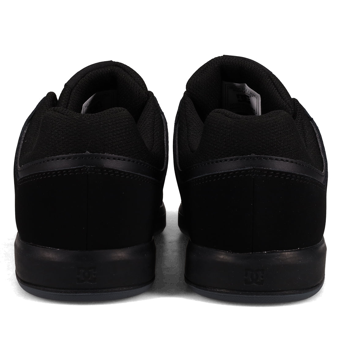 A pair of Men’s DC Cure Shoes by DC Shoes, featuring a black leather suede upper, displayed from the back and arranged side by side on a white background—ideal everyday footwear for any casual style.