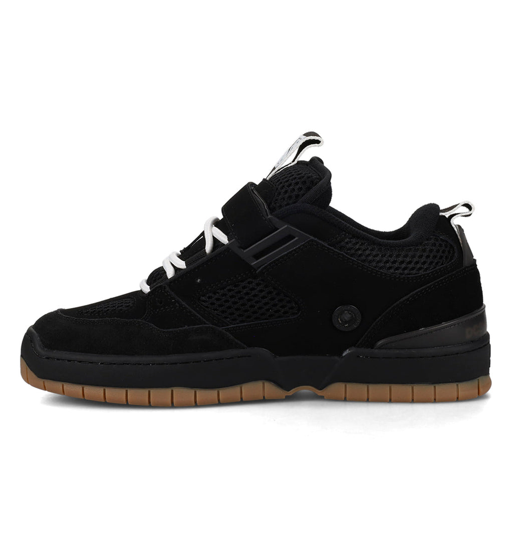 Black sneaker with brown sole on a white background