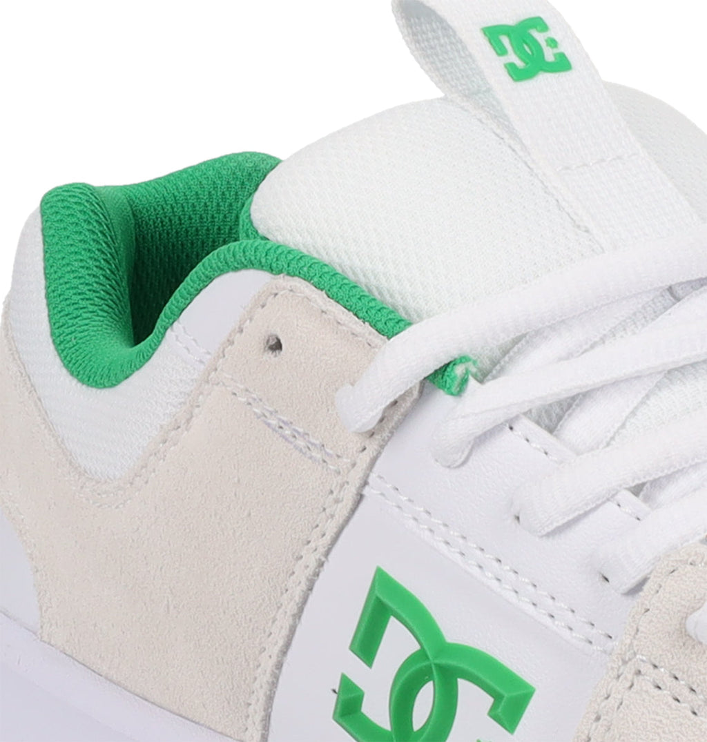 Close-up of the Men’s Lynx Shoes by DC Shoes in white and beige, featuring green accents such as the green DC logo, green lining, and green detailing on the tongue, with white laces—expertly crafted as classic skate footwear.