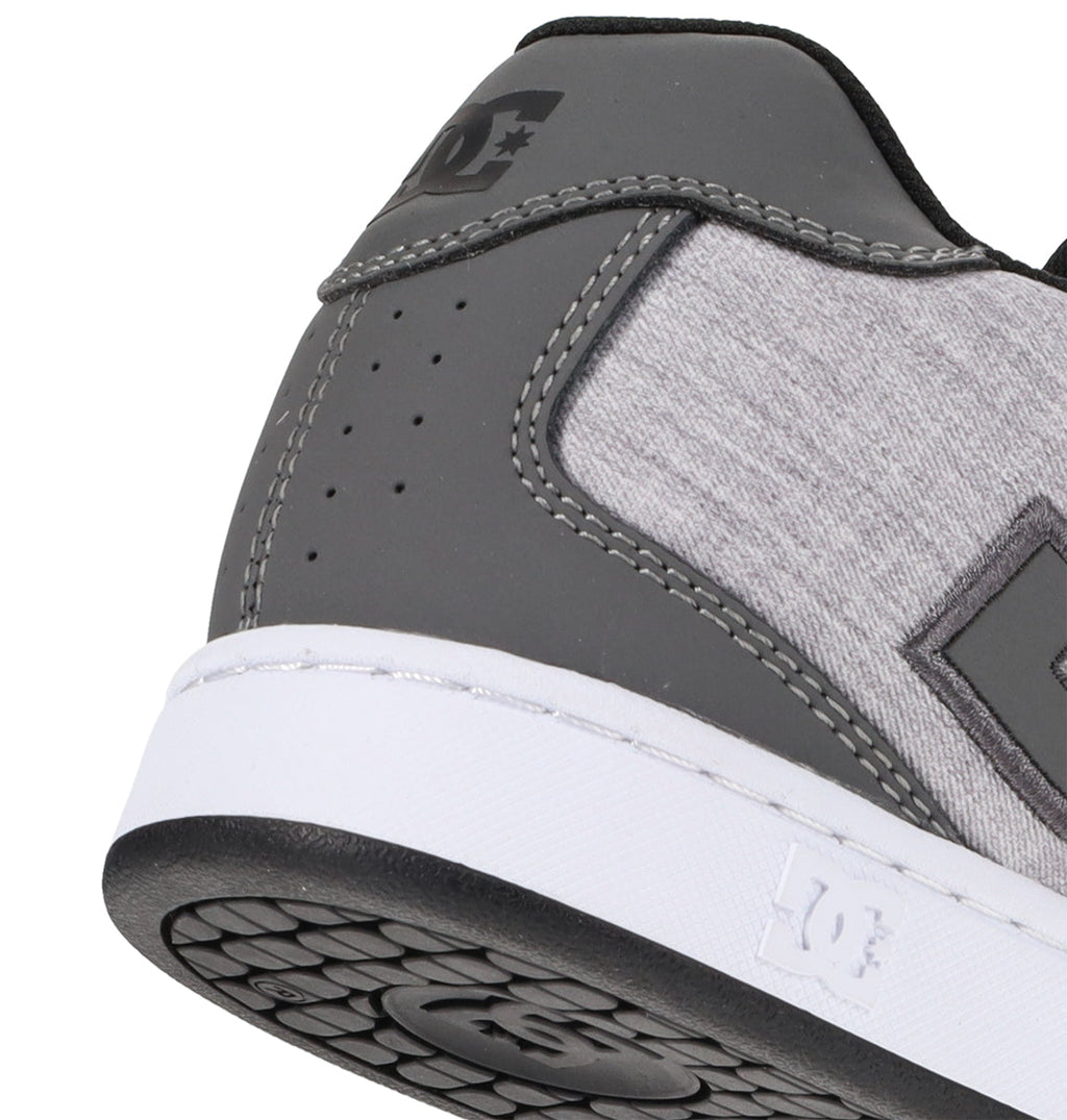 Close-up of the heel and side of a gray and light gray DC Shoes Men’s Net Shoe with a white sole, crafted from durable materials and featuring the DC Shoes logo on the side as well as embossed on the back of the midsole.