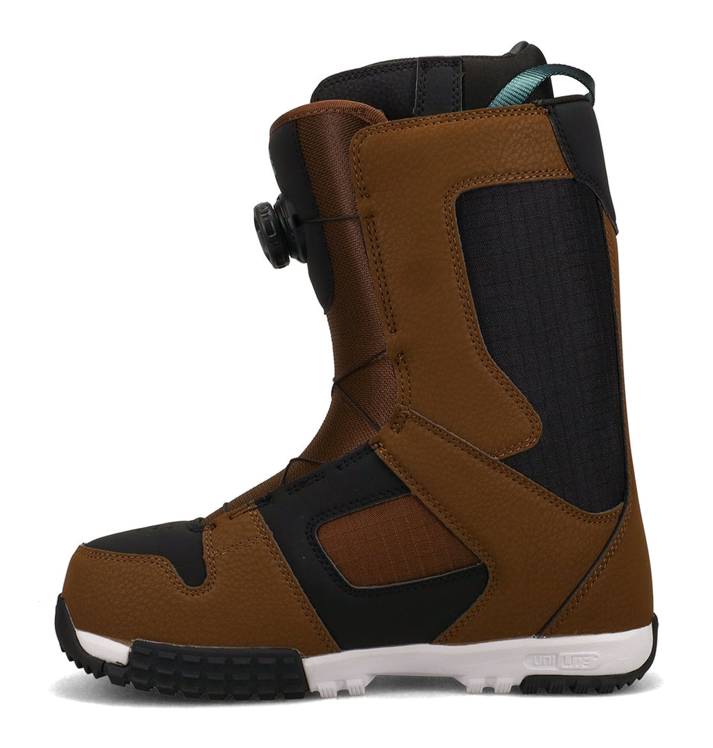 The DC Shoes Men’s Phase Boa Pro Snowboard Boots are shown in a side profile on a white background, featuring a brown and black design with white accents, a black sole, and a Boa Pro dial tightening system.