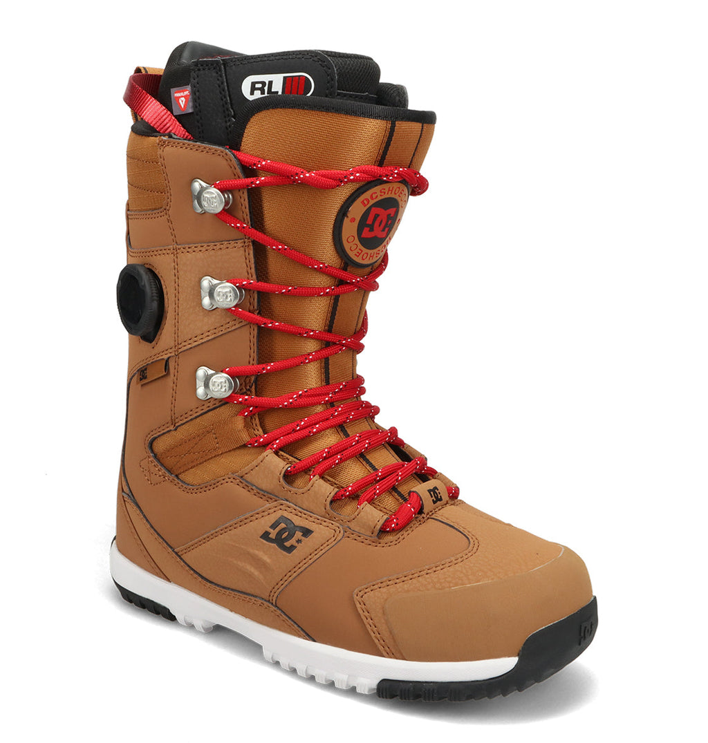 Discover the Men’s Premier Hybrid Snowboard Boots by DC Shoes—a tan snowboard boot featuring red laces, metal eyelets, a black side dial, black padded tongue and collar, and a white rubber sole—ideal for riders seeking versatile hybrid boots that fuse comfort with standout style.