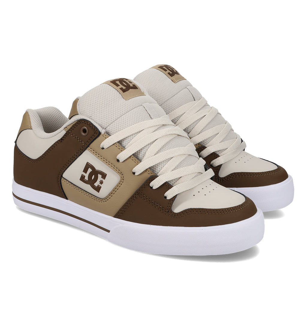 A pair of DC Shoes Men’s Pure Shoes in brown and beige with white laces and soles, displayed on a white background. These comfortable Men’s Pure Shoes are ideal for everyday use or skate park sessions.