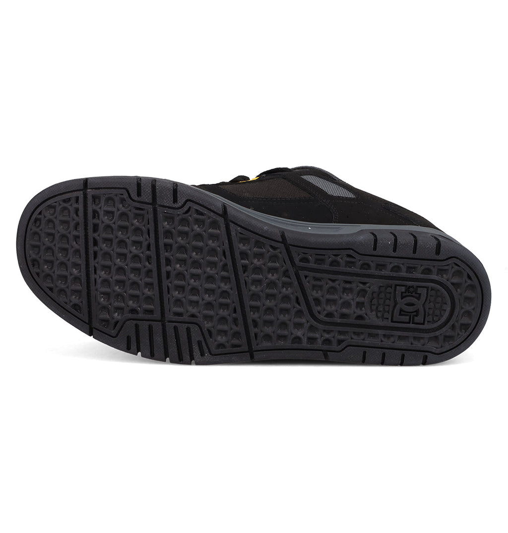 Bottom view of the Men's Stag Shoes by DC Shoes, featuring a textured, durable cupsole with geometric patterns and the embossed DC logo near the heel—a classic tribute to skate culture.