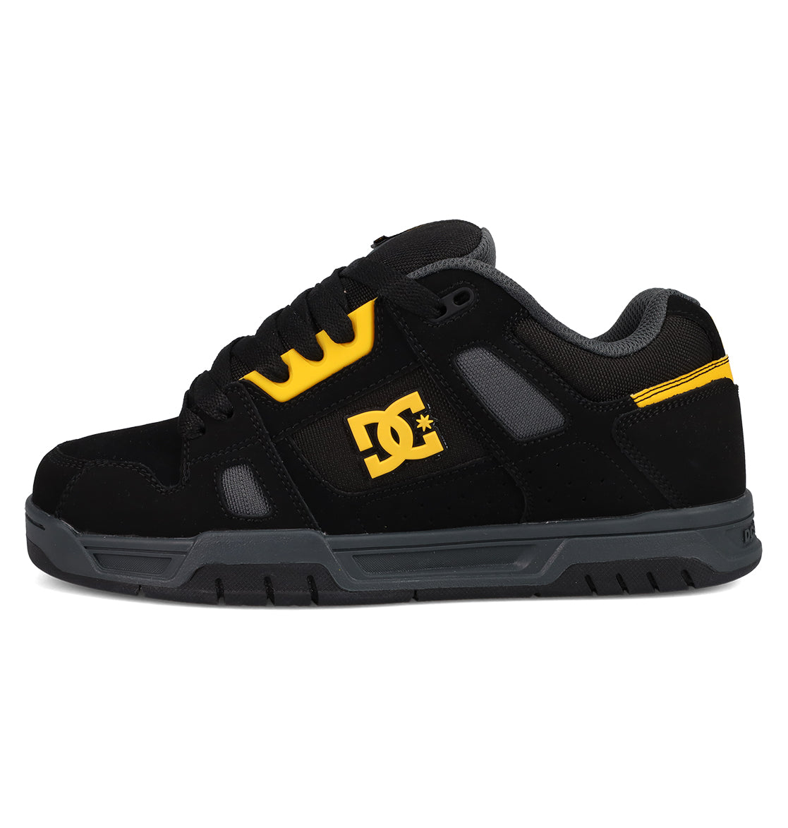 The Men's Stag Shoes by DC Shoes are black and gray skate sneakers with yellow accents, featuring the DC logo, black laces, gray rubber cupsole, a padded collar for comfort, and a low-top design inspired by skate culture.