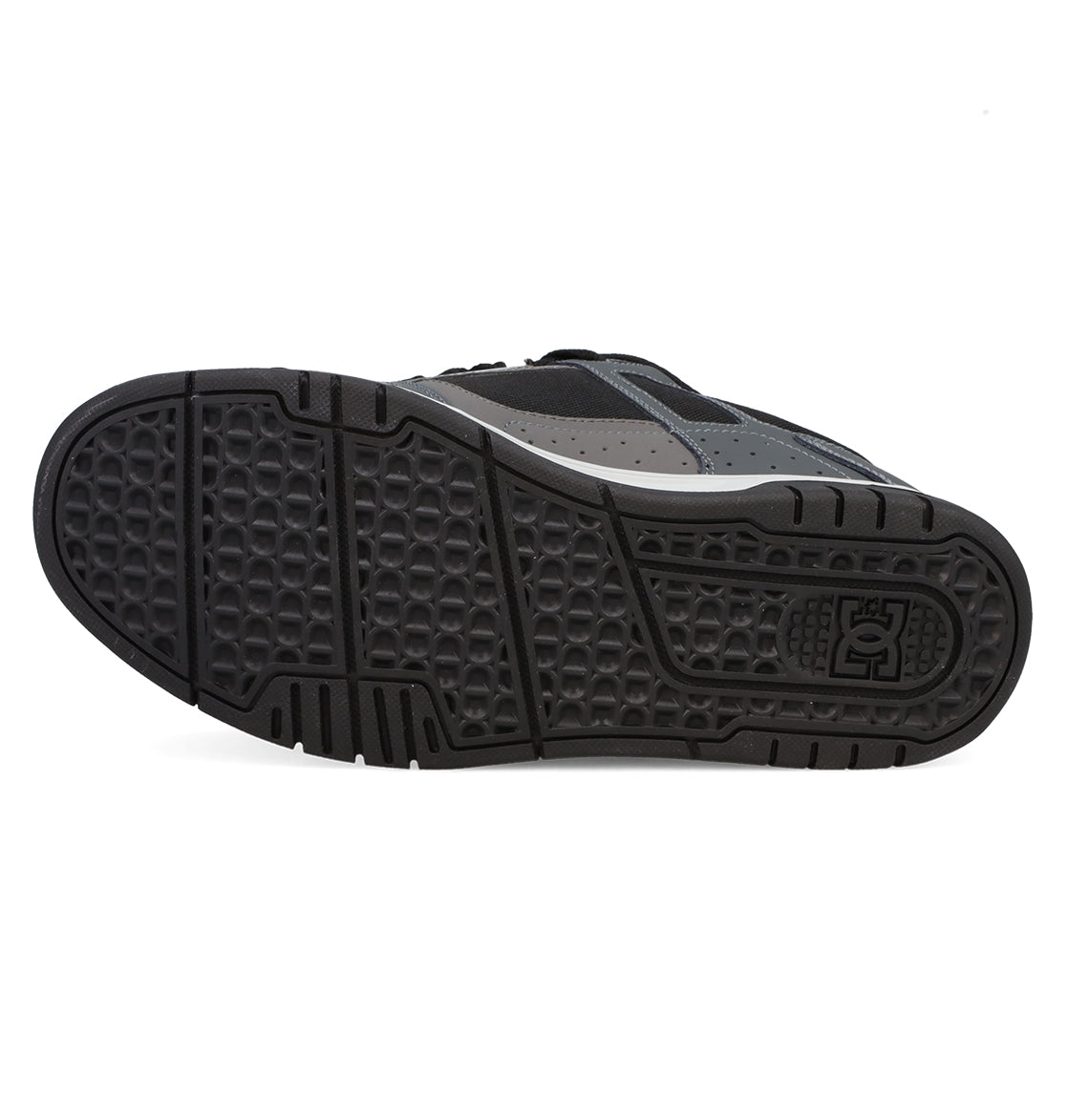 The image features the black rubber sole of the Men’s Stag Shoes by DC Shoes, showcasing a textured pattern with the DC Shoes logo near the heel and emphasizing its durable cupsole construction—a signature element appreciated in skate culture and characteristic of this model.