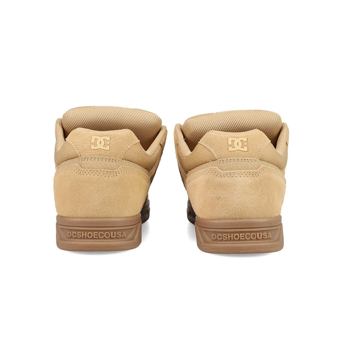A pair of tan DC Shoes Men's Stag Shoes seen from the back, featuring the DC logo on the heel, DCSHOECOUSA on the midsole, a suede finish, padded collars, and a classic cupsole design inspired by skate culture.