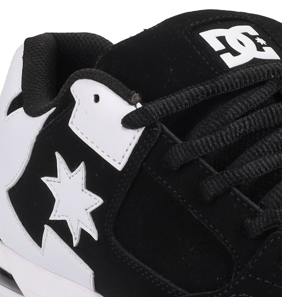 Close-up of the Men's Command Shoes by DC Shoes in black and white, showcasing the iconic logo on the tongue, black laces, and a star motif—combining classic DC style with modern sneaker features.
