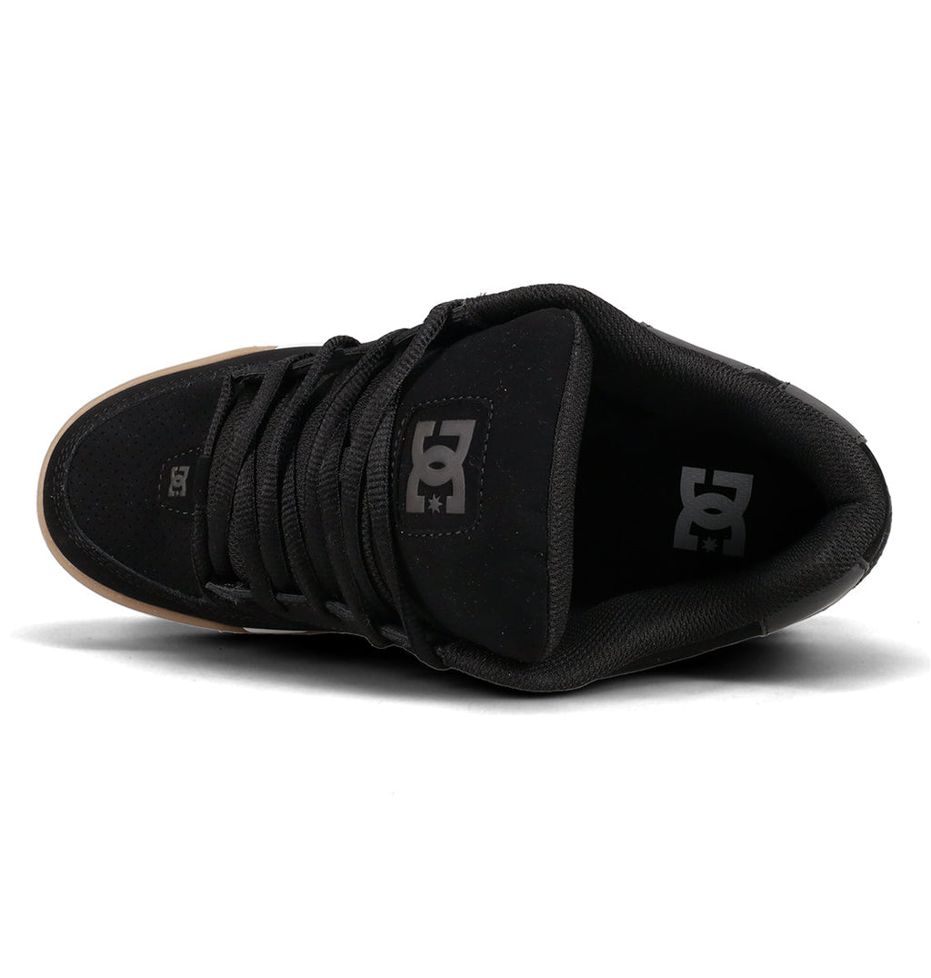 Here is a rewritten version using your product data: Top view of the Men’s Command Shoes by DC Shoes in black, showcasing black laces and a black tongue with the white DC logo. The brown outsole subtly contrasts with the predominantly black upper, while signature cushioning ensures comfort throughout this classic bulk silhouette from DC Shoes.