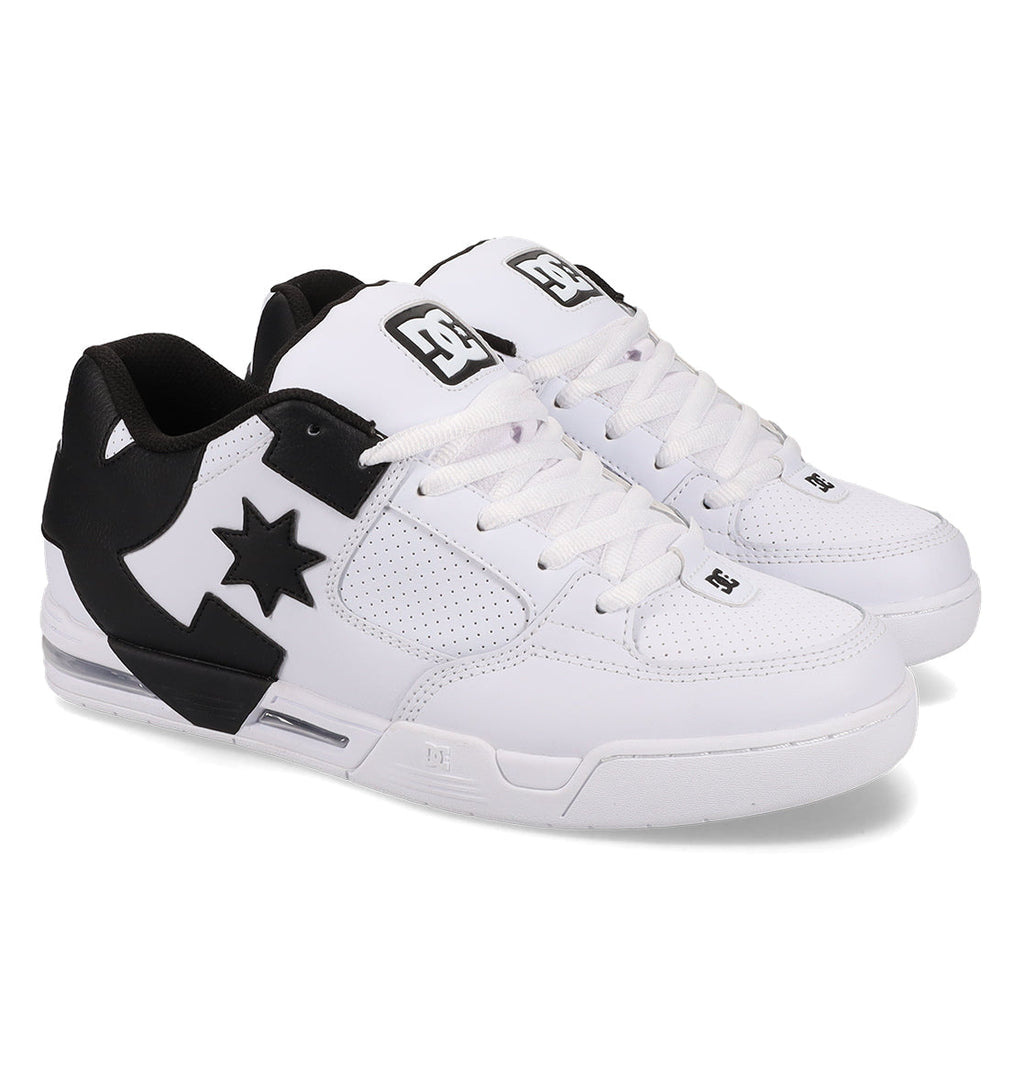 A pair of DC Shoes Men’s Command skate shoes in white and black, featuring perforated sides, signature DC bulk, a black star-shaped DC logo, white laces, and black accents on the heel and tongue for lasting comfort.