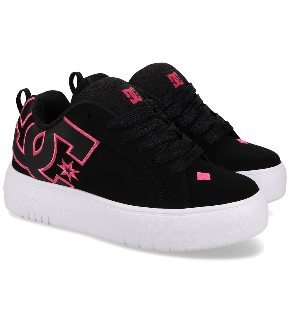 A pair of Women’s Court Graffik Platform Shoes by DC Shoes in black, featuring thick white soles and bold pink DC logos and accents, are displayed angled slightly to the right against a white background.