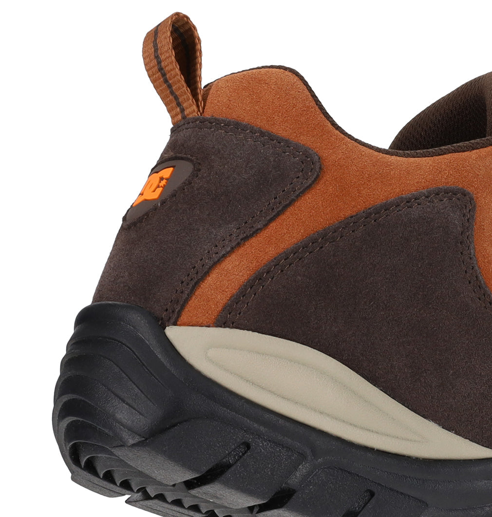 A close-up of the back and side of the DC Shoes Men’s Recon OG Shoes highlights the textured brown and orange suede material, black rubber sole, and an orange pull tab at the heel.
