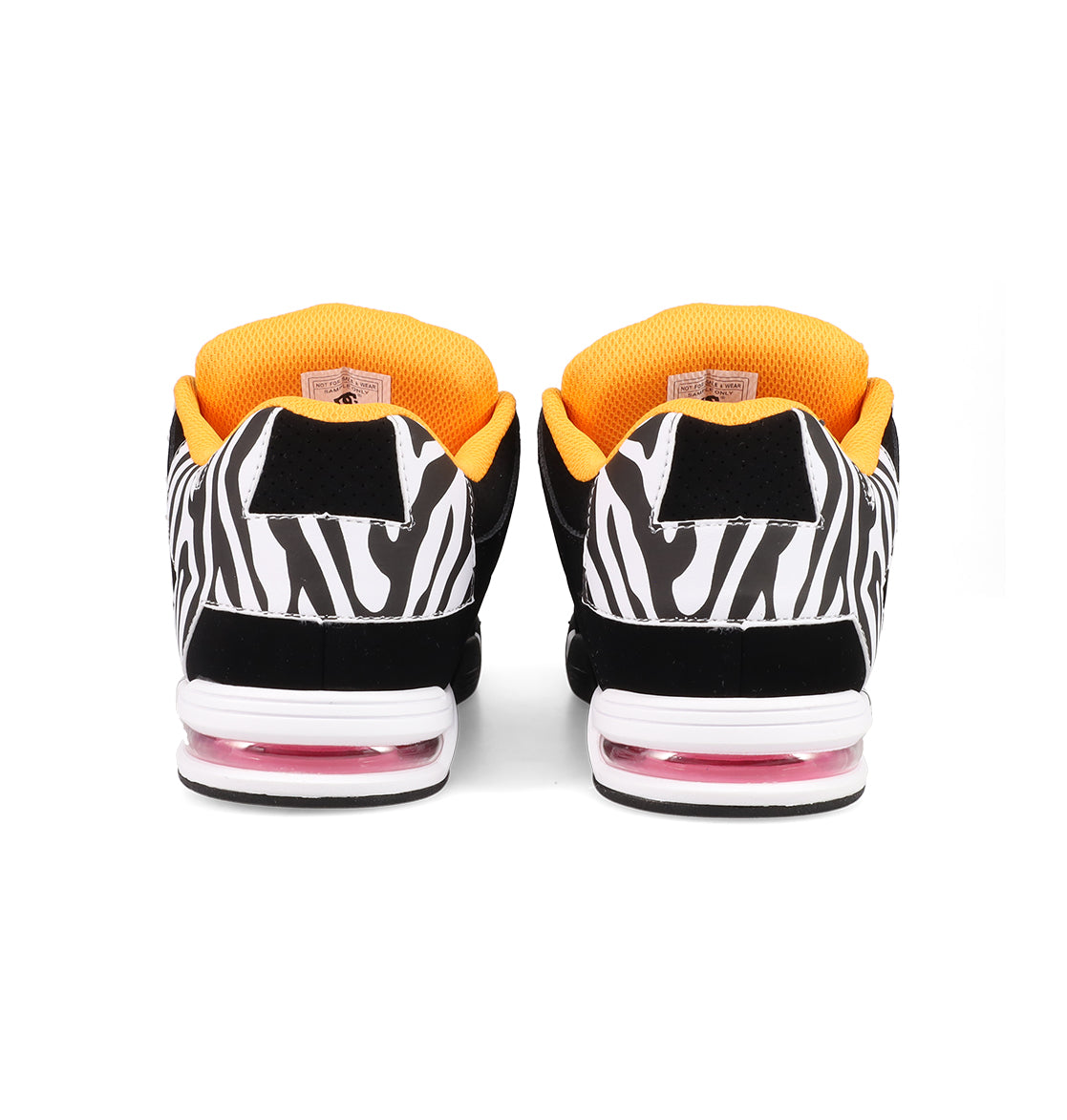 The Women's DC Command Shoes by DC Shoes showcase a bold black and white zebra print, orange inner lining, pink air cushions in the soles, and a streetwise design inspired by skateboarding heritage.