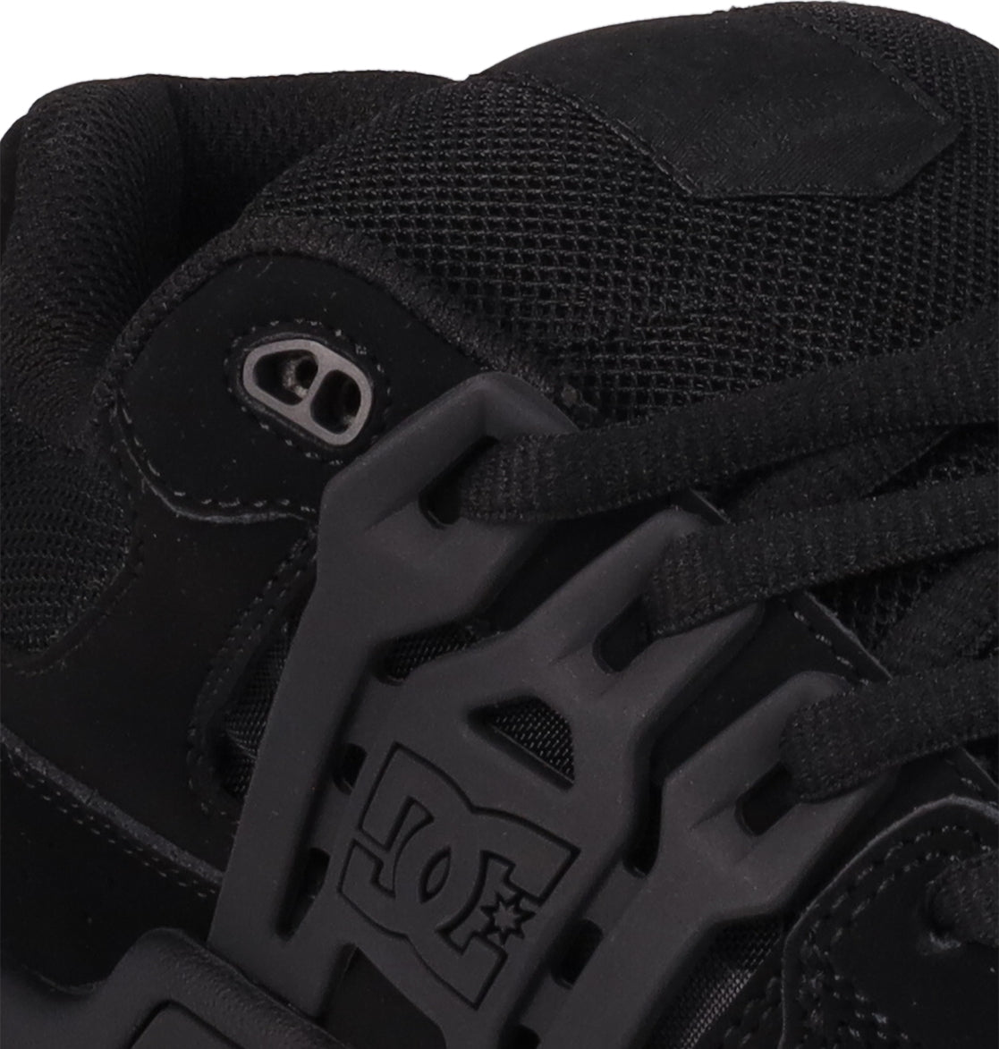 Close-up of DC Shoes Men's AT-2 skate shoe in black, featuring detailed stitching, black laces with metal eyelets, a DC Shoes logo on the plastic lace guard, and an Airband outsole.