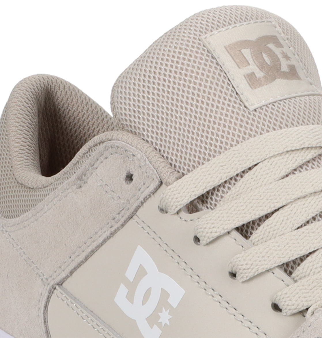 Close-up of a beige DC Shoes Men’s Onyx Skate Shoe highlighting the mesh tongue, suede side, and laces, with the DC logo visible on both the tongue and side of the shoe. This minimal silhouette makes it an ideal everyday vulc skate shoe for effortless style and comfort.