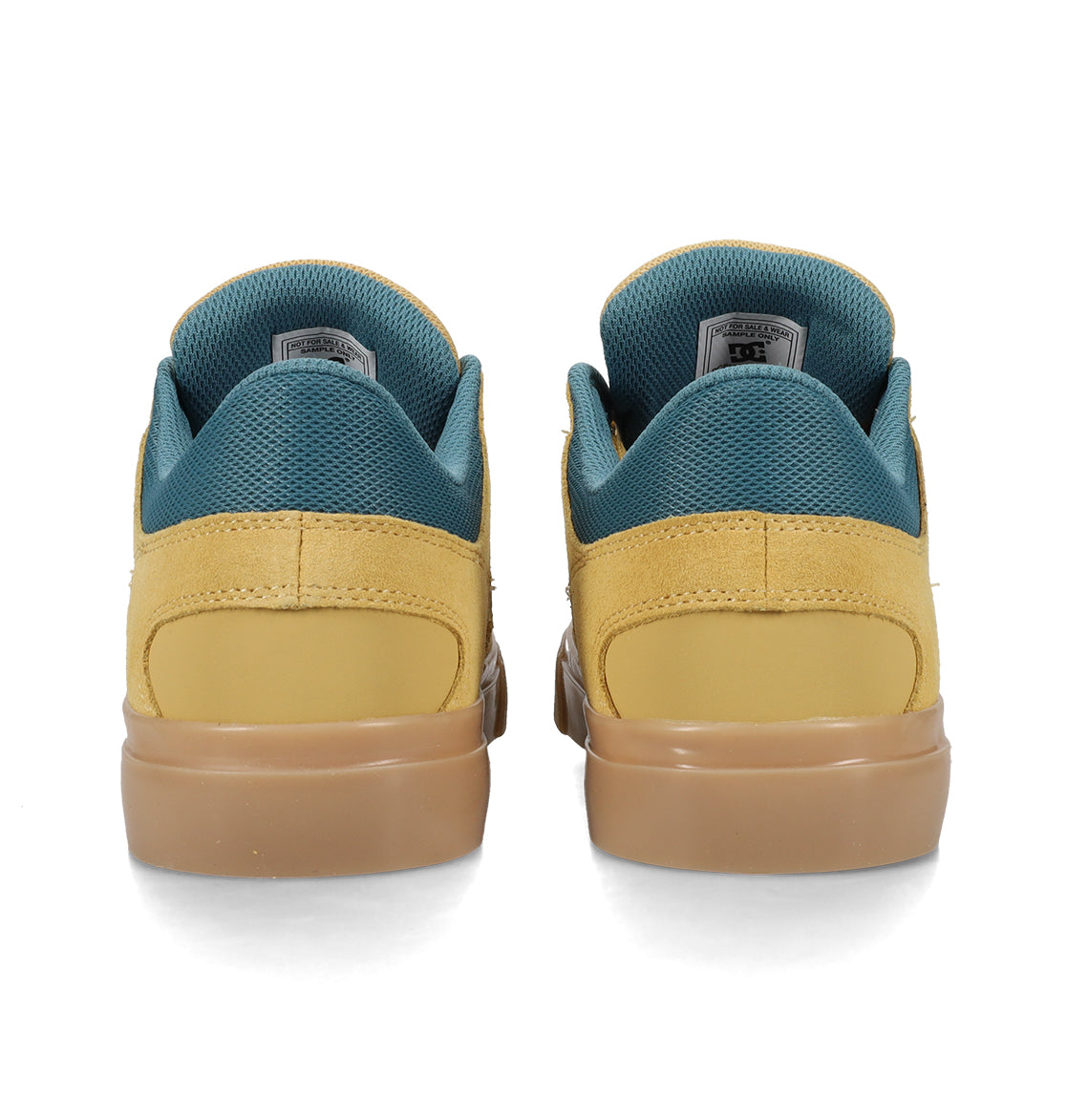 A pair of DC Shoes Men’s Onyx Skate Shoes in yellow with teal lining and brown soles, shown from the back against a white background, features a minimal silhouette reminiscent of the classic vulc shoe style.