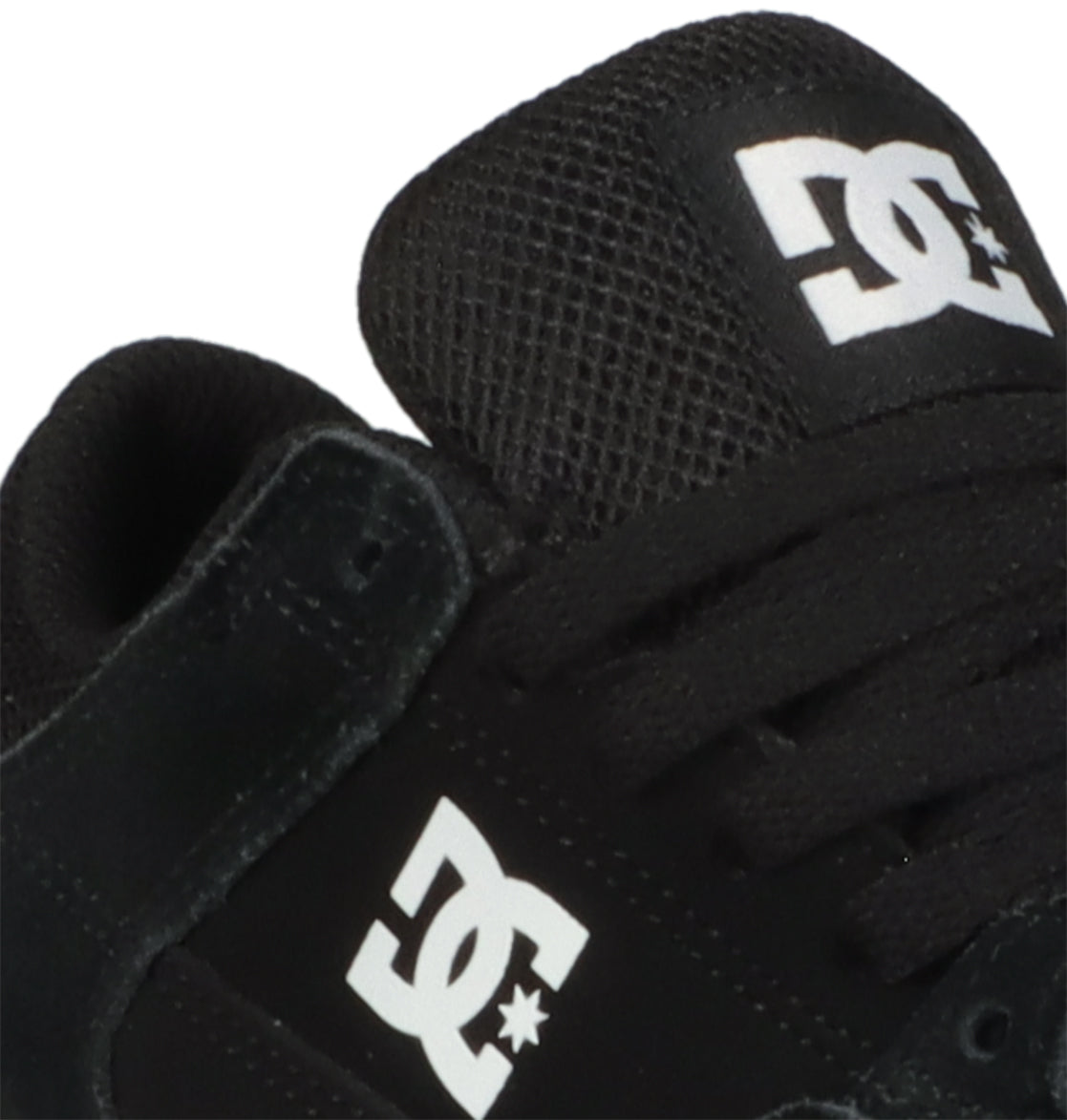 Close-up of the Kids’ Onyx Shoes in black, showcasing the white DC Shoes logo on the tongue and side, complemented by black laces and a mesh-textured upper. This minimal silhouette from DC Shoes offers an ideal everyday option for kids seeking style and comfort in a classic vulcanized design.