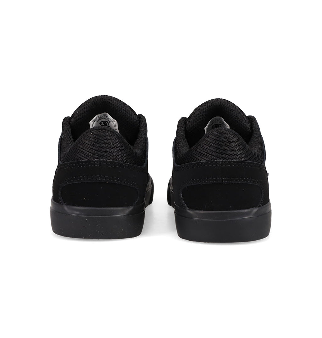 A pair of Kids' Onyx Shoes by DC Shoes, featuring a minimal black silhouette, are shown from the back side by side on a white background—perfect everyday sneakers.