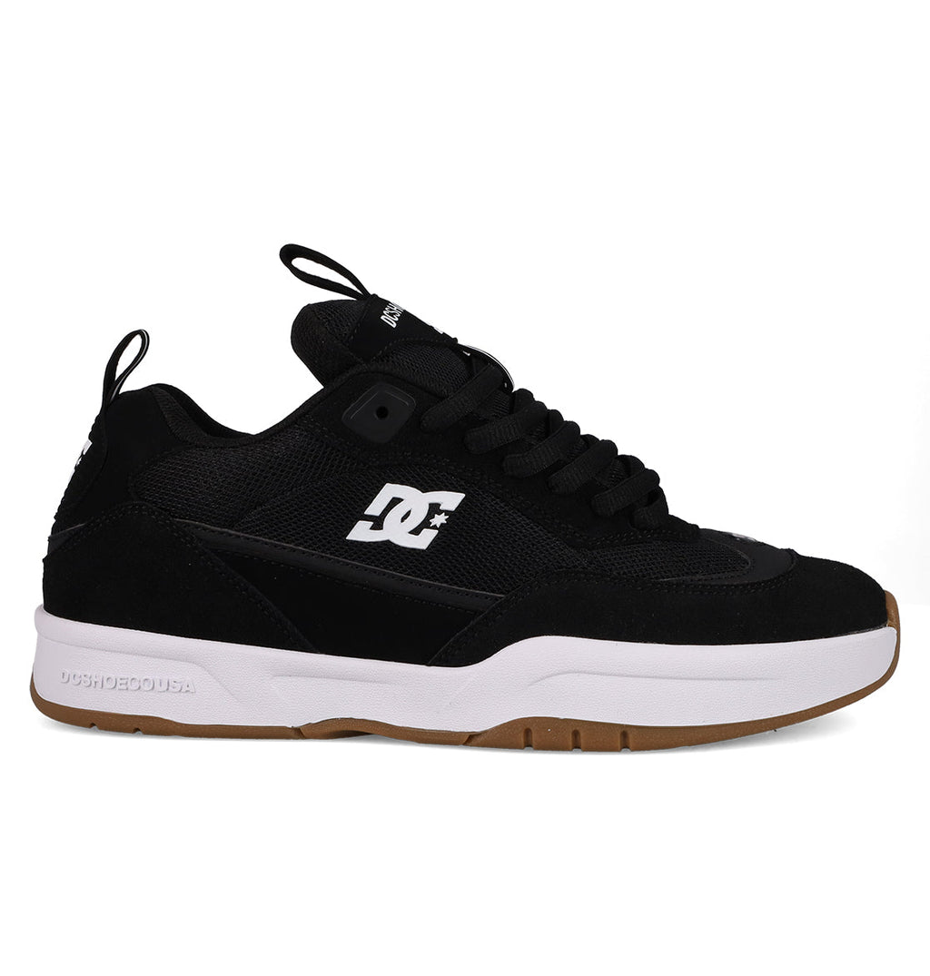 The DC Shoes Men's JS-2 Shanahan Pro Skate Shoes feature a black upper, white side logo, black laces, thick white midsole, and brown rubber outsole. Inspired by John Shanahan and shown on a plain white background.
