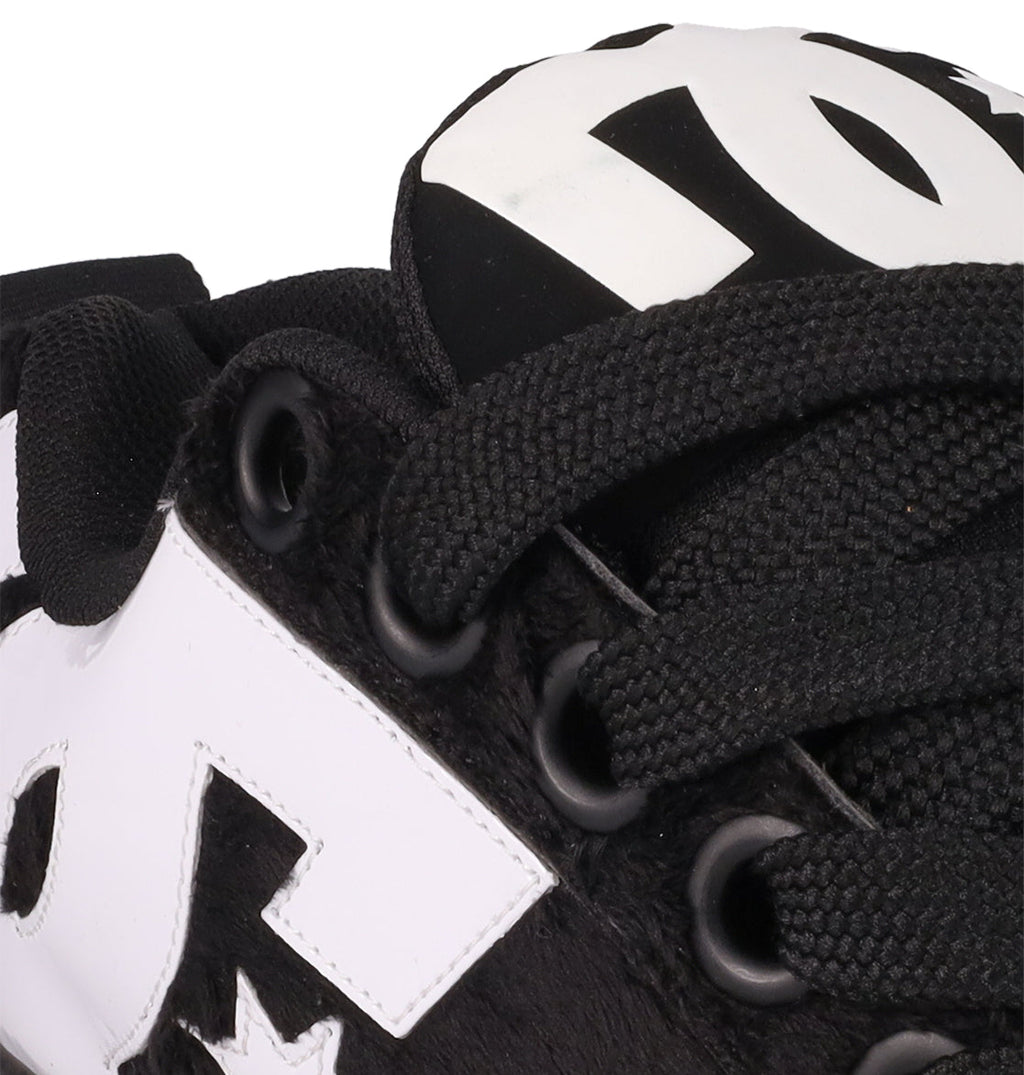 Close-up of DC Shoes Men's Court Graffik Puff Shoes in black, featuring thick laces, black eyelets, a bold white DC logo on the side and tongue, and an exaggerated puffy upper for standout style.