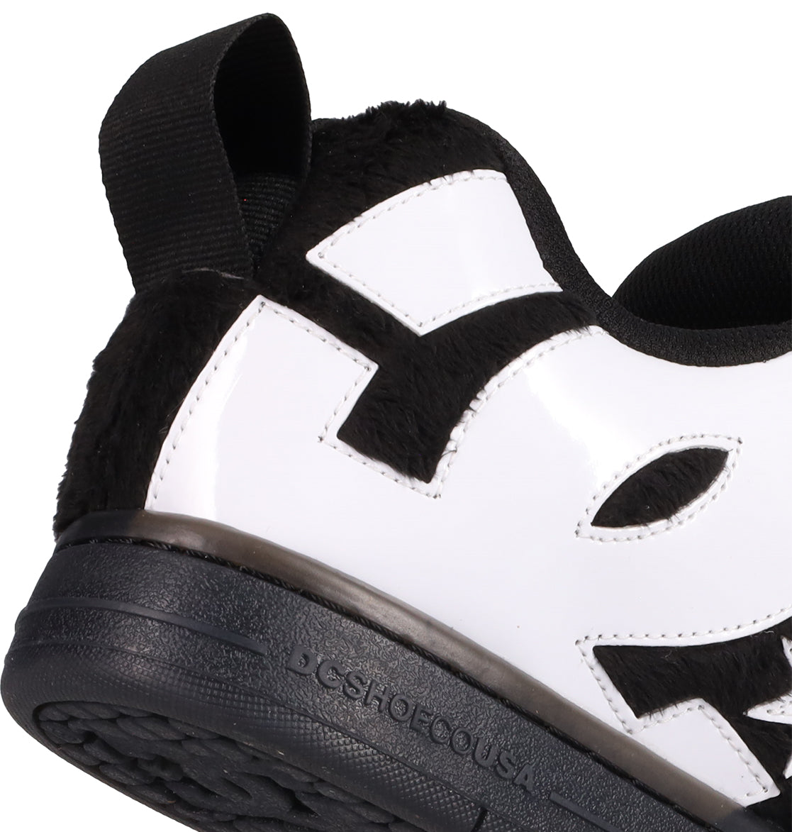 Close-up of the Men's Court Graffik Puff Shoes by DC Shoes, featuring a black sole, exaggerated black and white upper, fuzzy black heel, stitched details, and "DCSHOECOUSA" embossed near the heel.