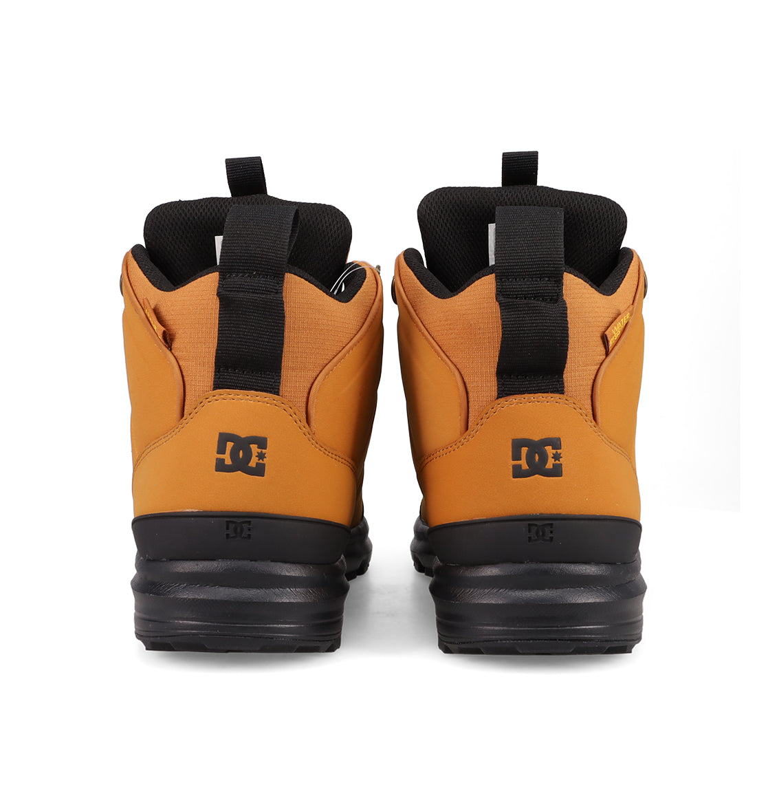 A pair of tan and black Men's DC Tarmont Shoes by DC Shoes, shown from the back with black pull tabs and visible DC logo on each heel—ideal for street style and all-weather wear.