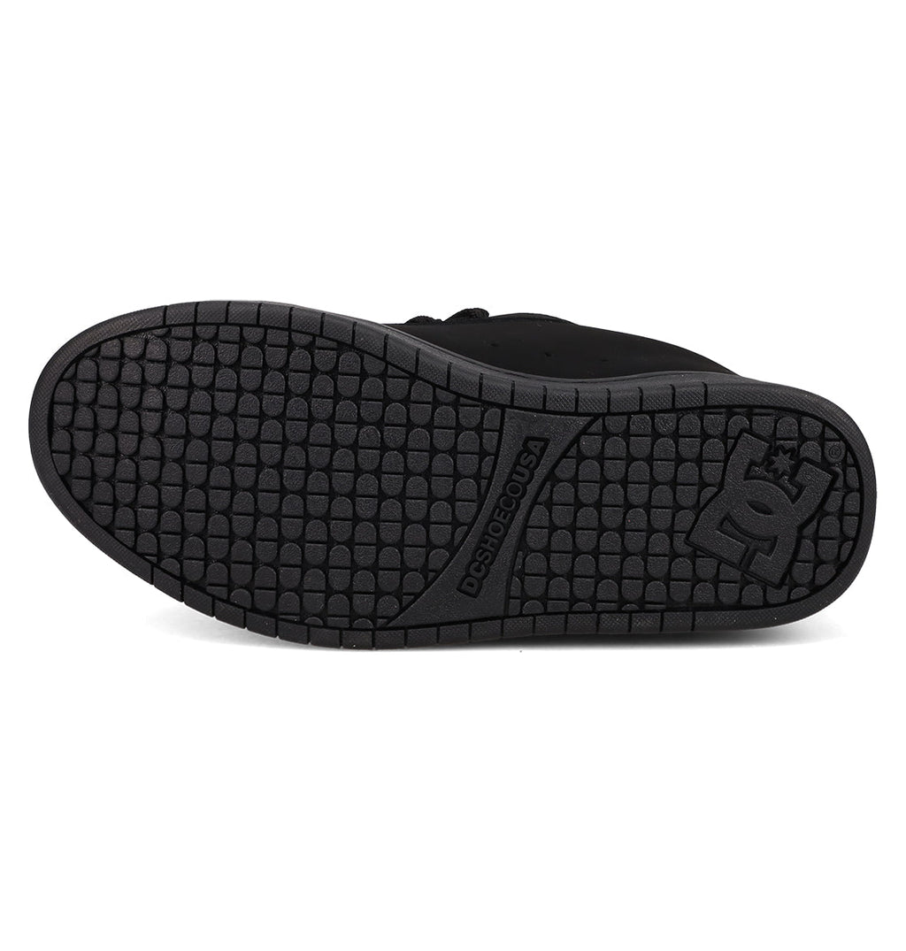 The image features the black rubber sole of the DC Shoes Men’s Court Graffik Day Of The Dead sneaker, displaying a textured tread pattern and the DC Shoes logo near the heel, from their vibrant Day of the Dead Collection inspired by Día de los Muertos.