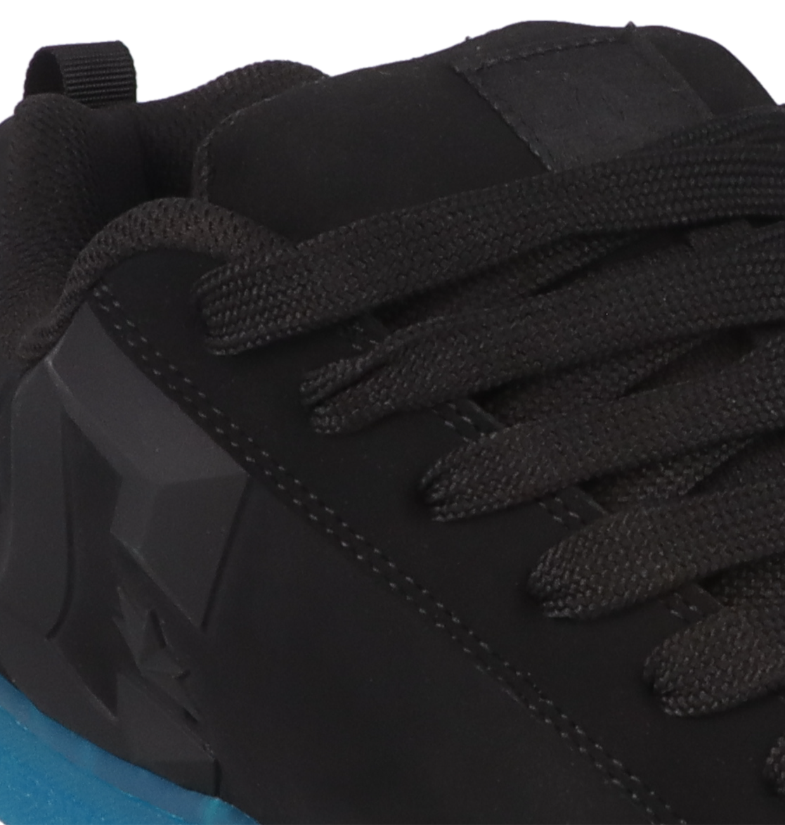 Close-up of the Women’s Court Graffik Beveled Shoes by DC Shoes in black, featuring matching black laces, a blue sole, and a textured design near the heel. Prominent DC branding and detailed stitching accent the sides, all set on the classic puffy silhouette that defines this style.