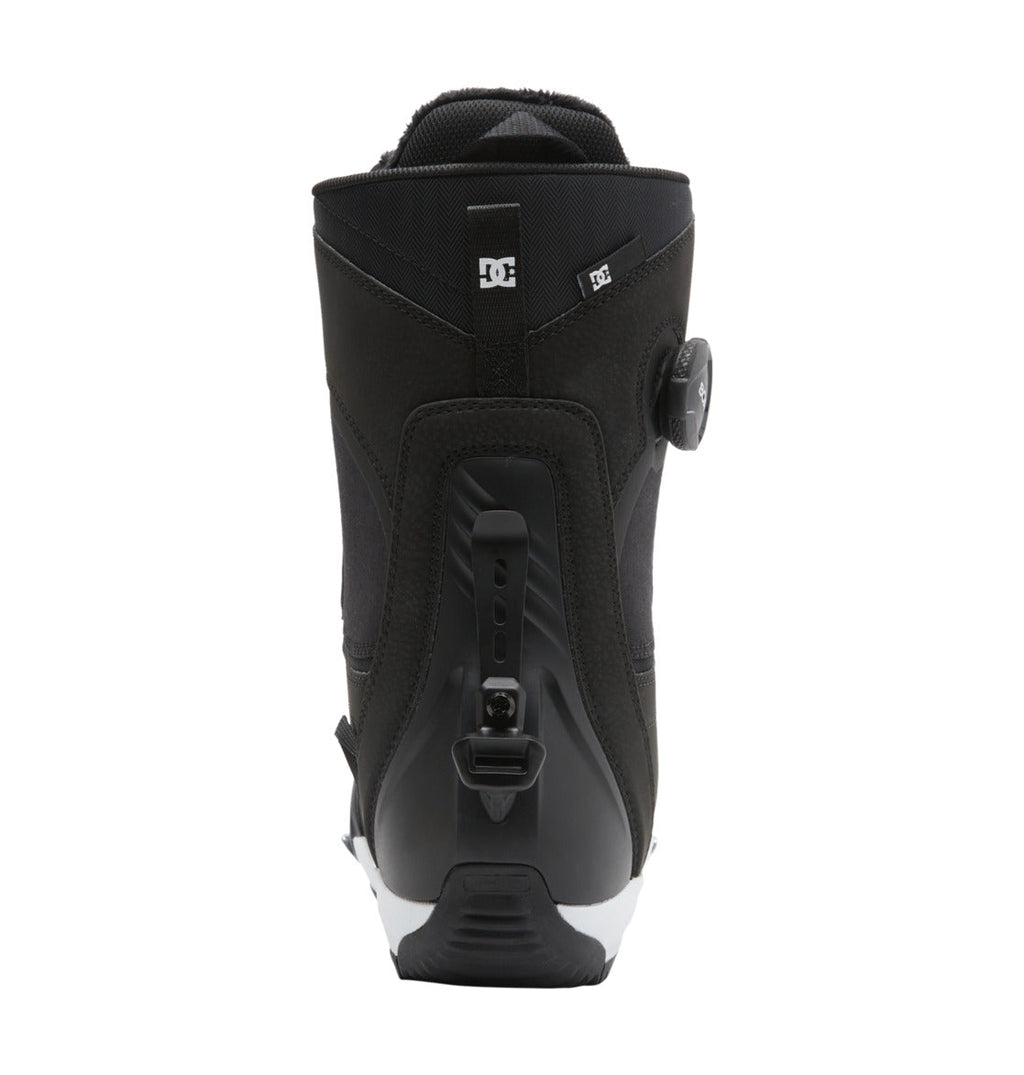 Rear view of the DC Shoes Women’s Lotus Step On® Snowboard Boots in black, highlighting the Dual Zone BOA Fit System with a side-mounted dial adjustment, heel strap, and DC logo near the top. The boots are displayed on a white background.