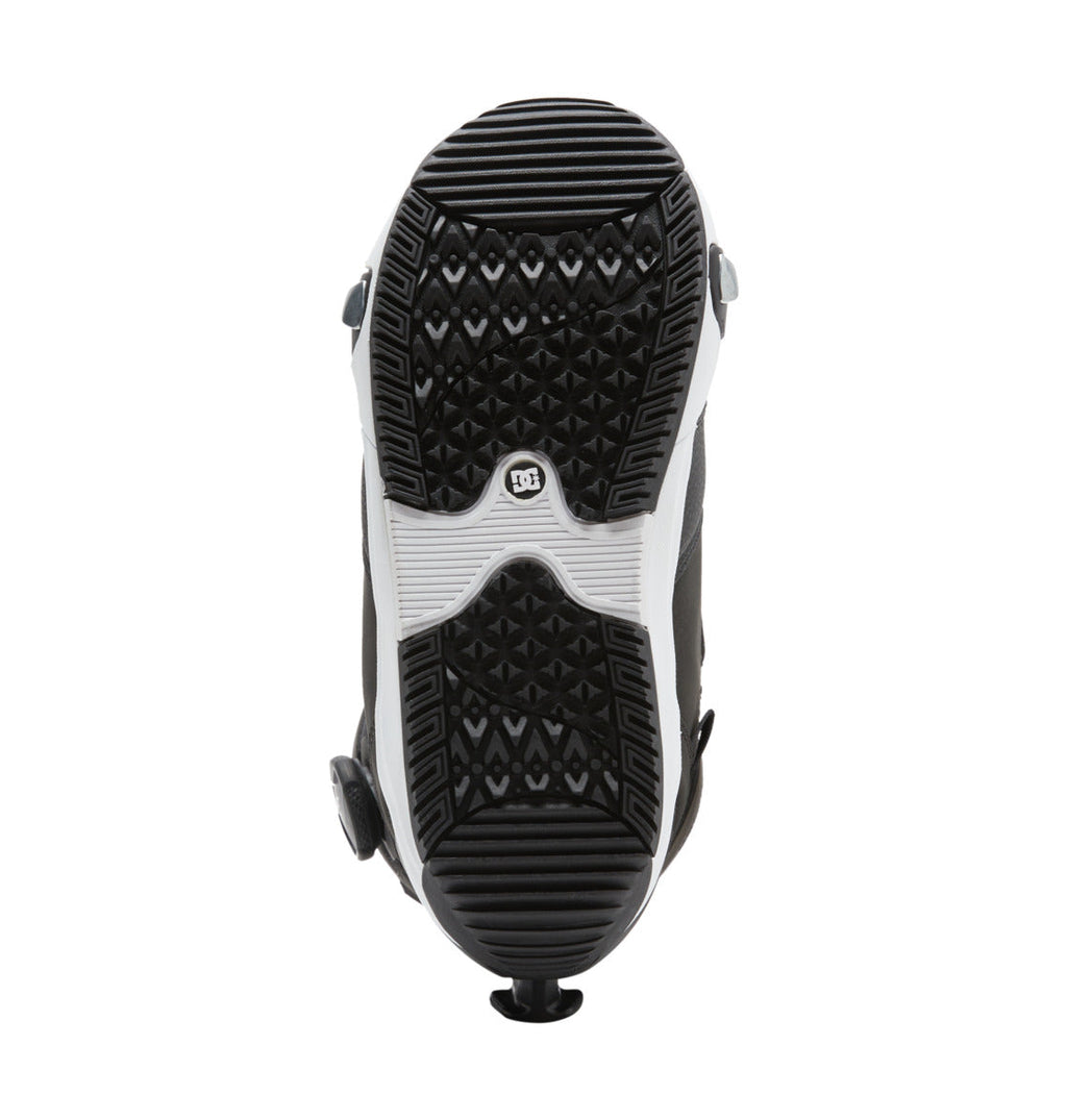 Sole view of the DC Shoes Women’s Lotus Step On® Snowboard Boot in black and white, featuring textured grip patterns and adjustment dials on the sides utilizing the Dual Zone BOA Fit System for precise, customized comfort.