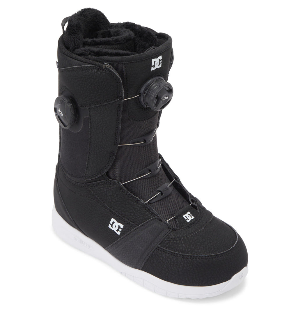 Introducing the Women’s Lotus BOA® Snowboard Boots by DC Shoes—a black boot with a white sole, featuring the Dual Zone BOA® Fit System for precise lacing adjustment and signature DC branding on the side and tongue. Designed for comfort and durability, it’s equipped with a lightweight UNILITE outsole.