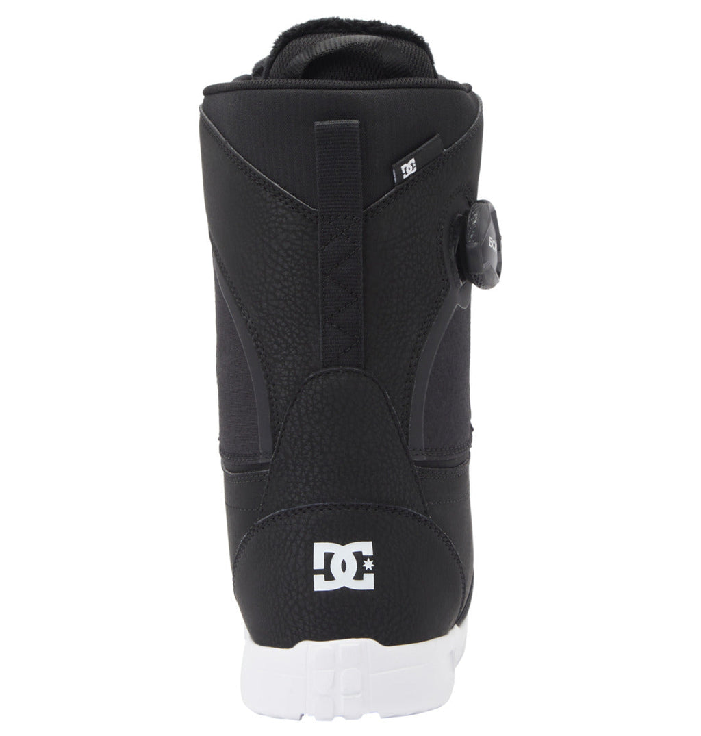 The DC Shoes Women's Lotus BOA® Snowboard Boot in black is shown from the back, featuring a white DC logo near the heel, a side Dual Zone BOA Fit System dial, textured and smooth panels, and a white UNILITE outsole.