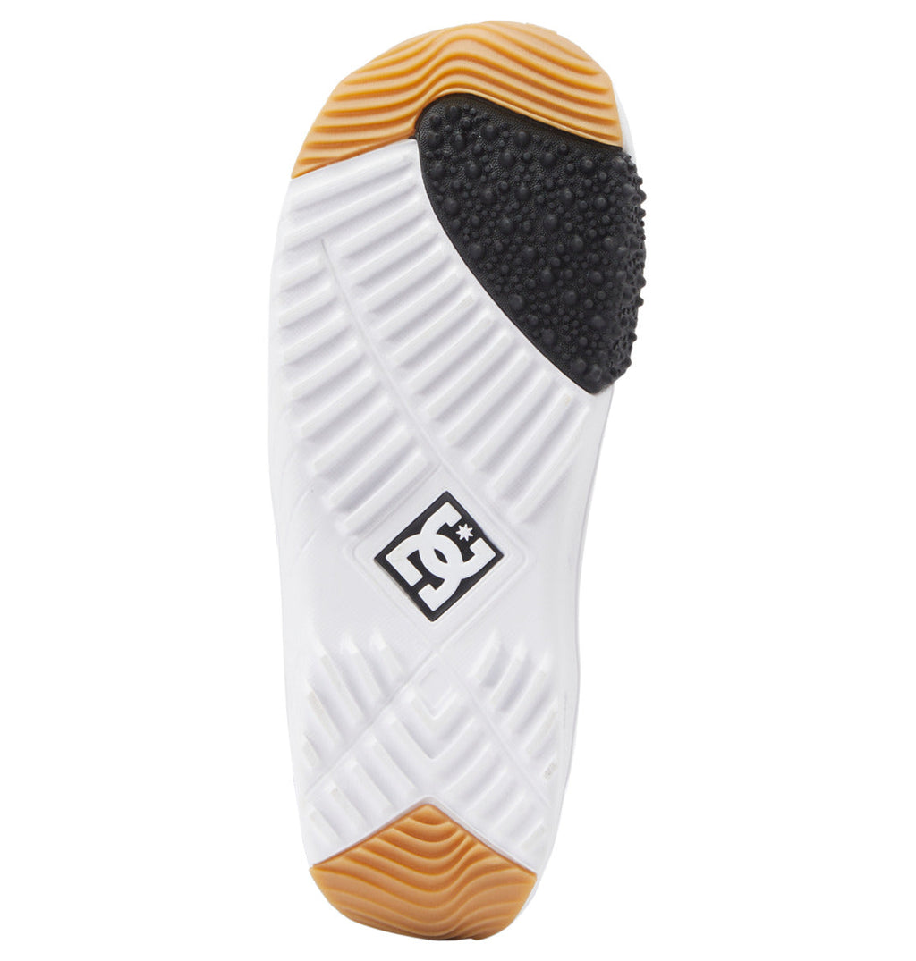 DC Shoes sole view featuring a white textured outsole with a diamond tread pattern, black rubber toe cap, gum rubber accents at the heel and toe, and a DC logo badge in the center—just as seen on the Women’s Mora BOA® Snowboard Boots by DC Shoes, equipped with the responsive BOA® Fit System.