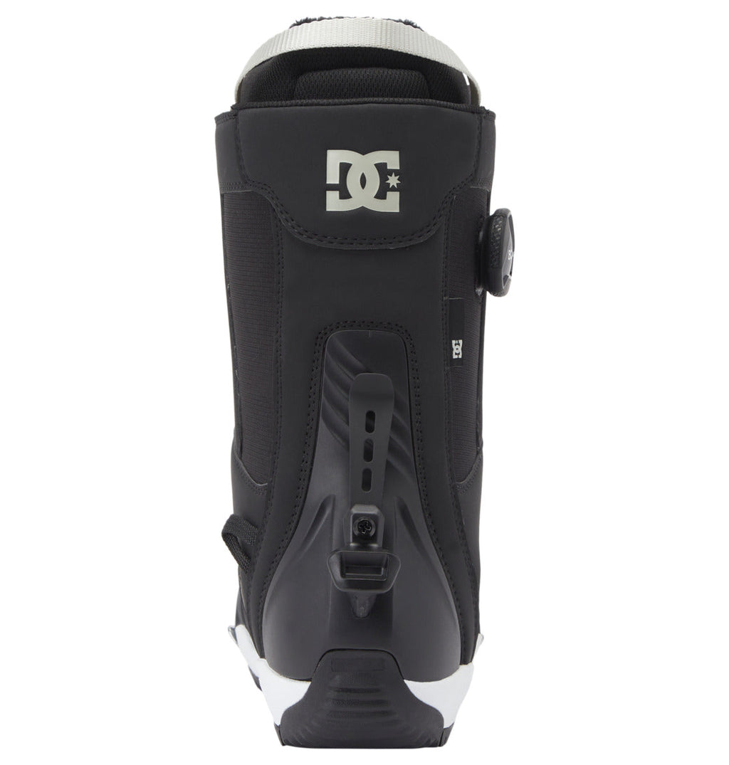 A black DC Shoes Women’s Phase Pro Step On BOA® Snowboard Boot, viewed from the back, displays the logo at the top, an adjustable BOA® Fit System dial on the side, and a heel lock mechanism at the base. This Step On® model is designed for secure comfort and easy entry.