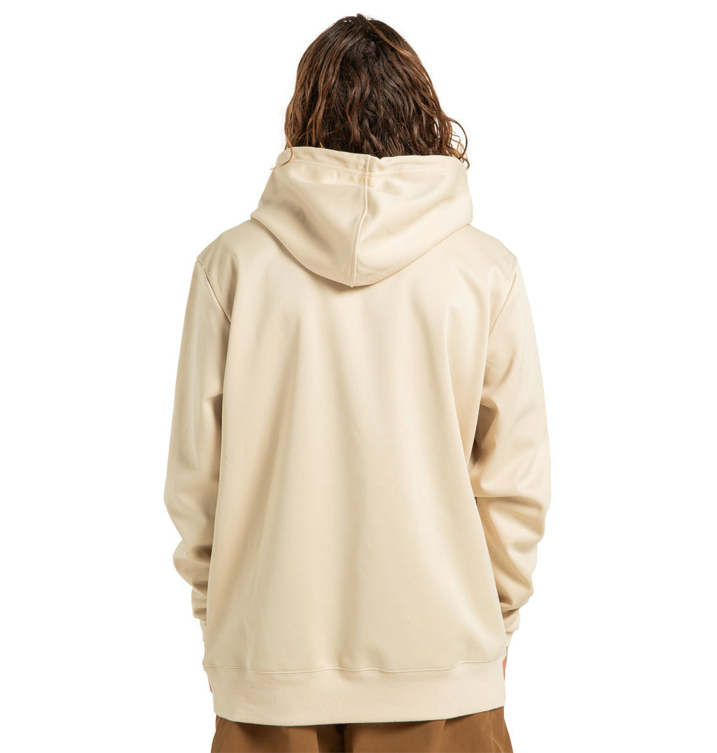 A person with long, wavy brown hair is shown from the back against a white background, wearing a light beige DC Shoes Unisex Snowstar Hoodie made from polyester bonded fleece and paired with brown pants. The hoodie by DC Shoes provides reliable weather protection while ensuring both style and comfort.